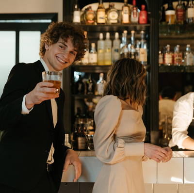 A photo of a man raising a glass while dating a girl