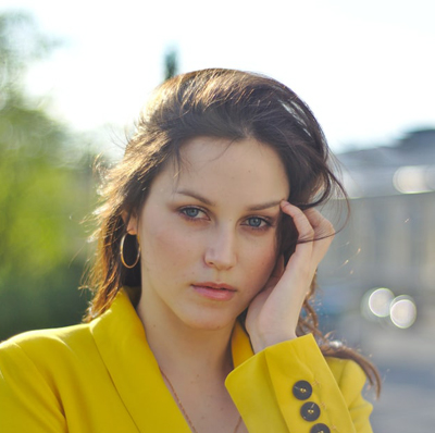 A Russian woman in a yellow coat. 