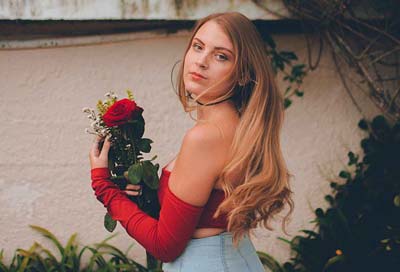 A beautiful Russian woman holding a rose